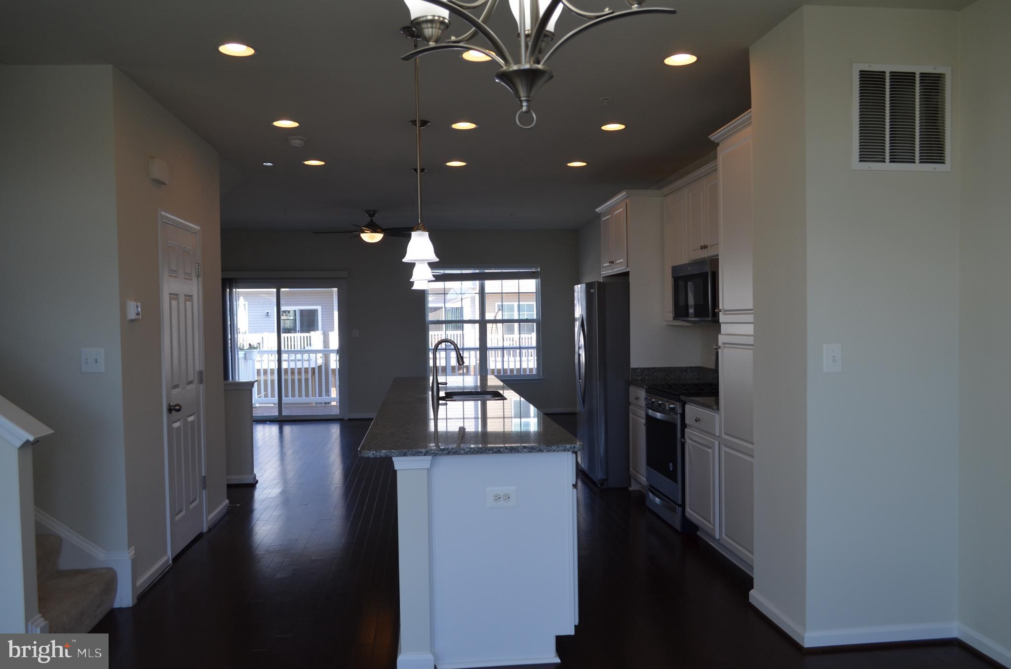 6004 Forum Frederick, MD 21703 - Photo 5 of 30 a view of entryway with livingroom and wooden floor