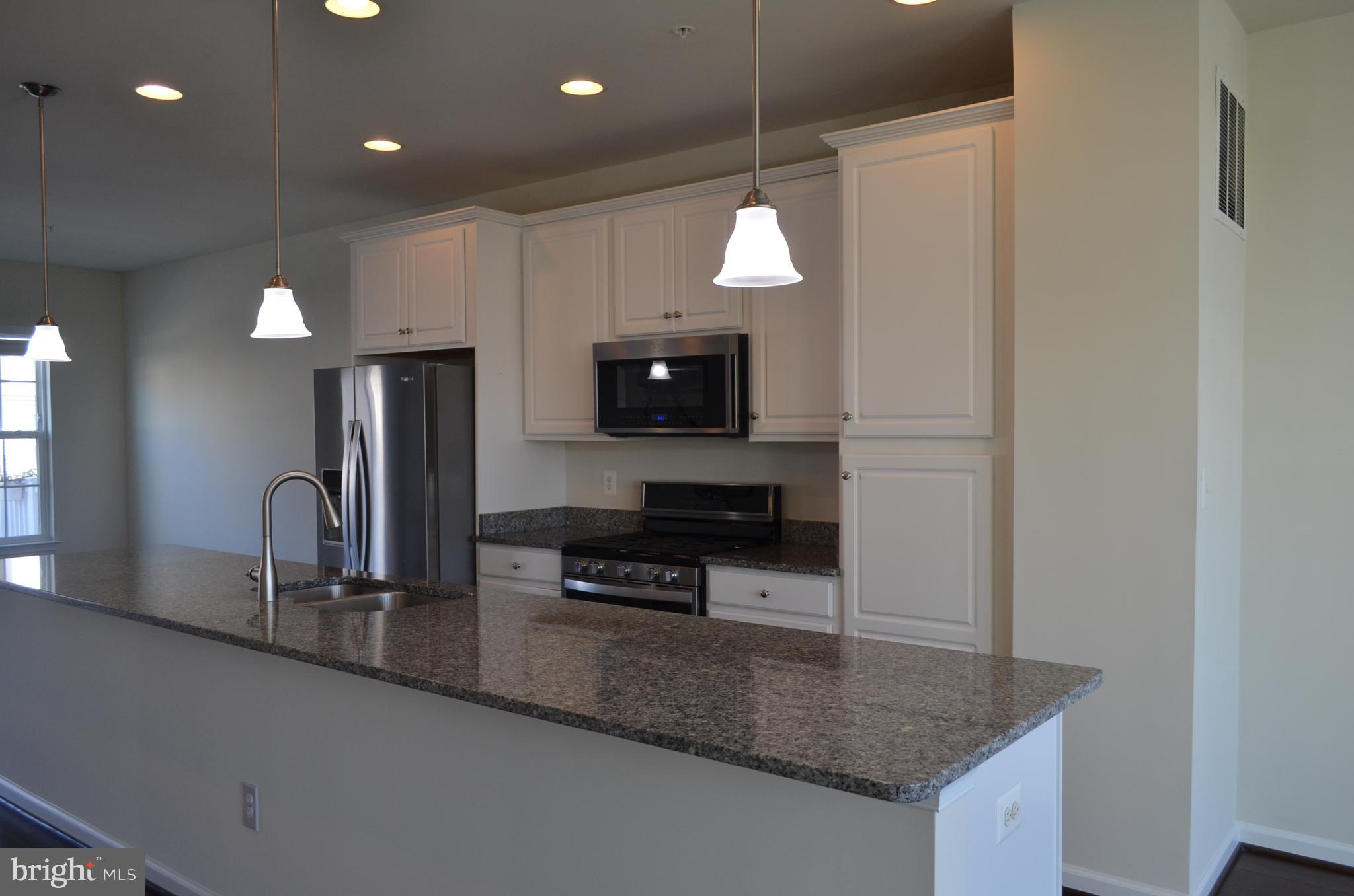 6004 Forum Frederick, MD 21703 - Photo 7 of 30 a kitchen with granite countertop a sink a stove and a refrigerator