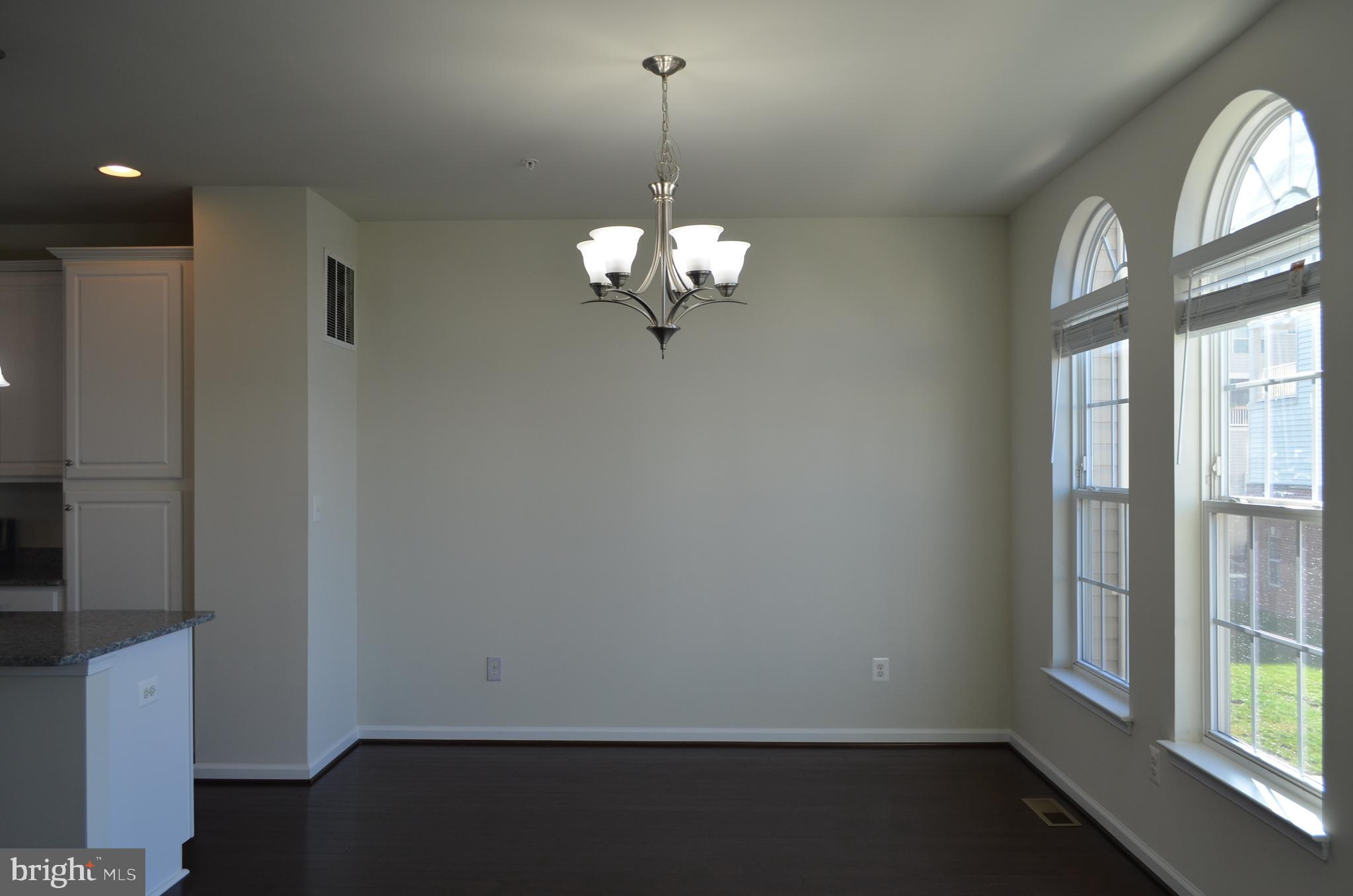 6004 Forum Frederick, MD 21703 - Photo 8 of 30 a view of a chandelier in big room and chandelier fan