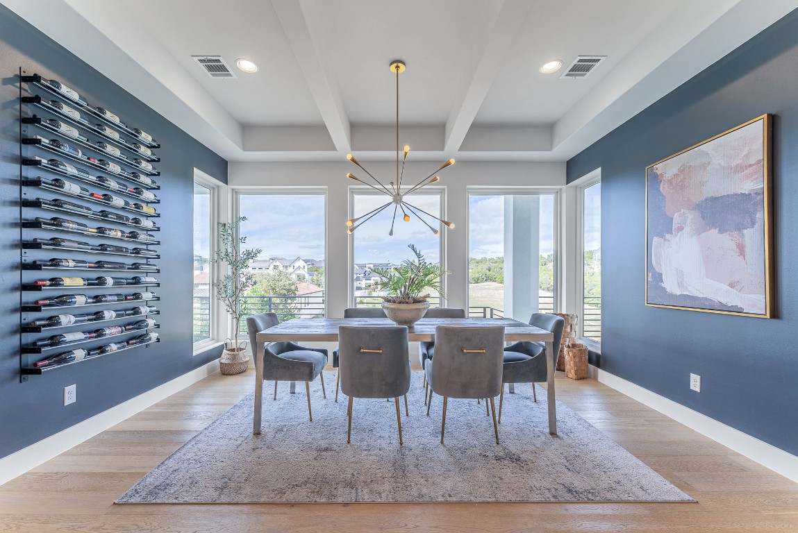a view of a dining room with furniture wooden floor and chandelier