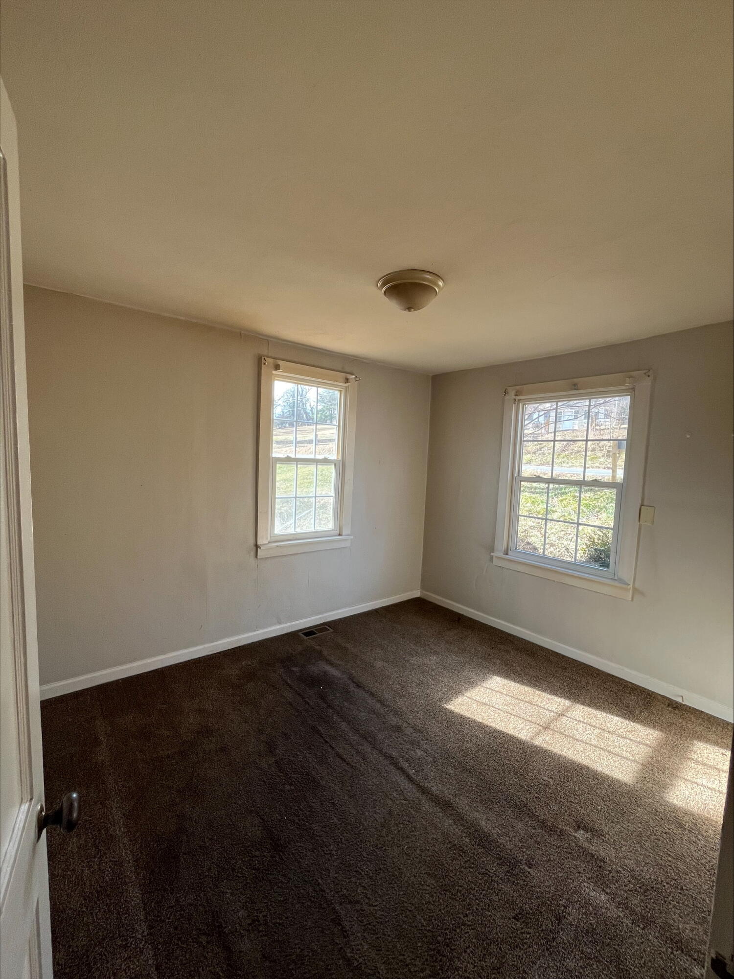 4529 Old Mountain Road Northeast Roanoke, VA 24019 - Photo 13 of 18 a view of an empty room with wooden floor and a window
