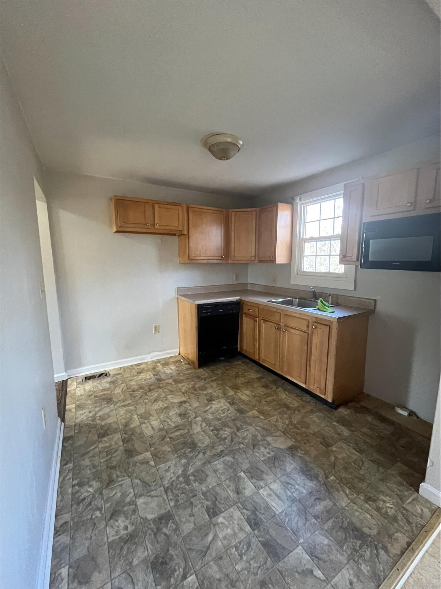 4529 Old Mountain Road Northeast Roanoke, VA 24019 - Photo 2 of 18 a large kitchen with granite countertop a sink and a stove top oven