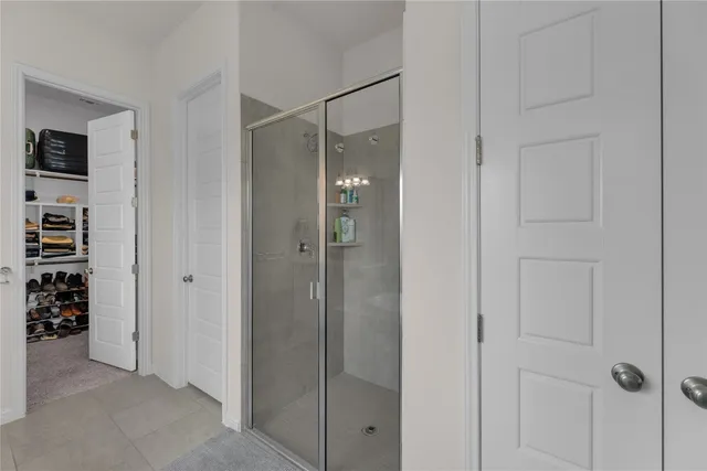 a spacious bathroom with a granite countertop sink a toilet a mirror and shower