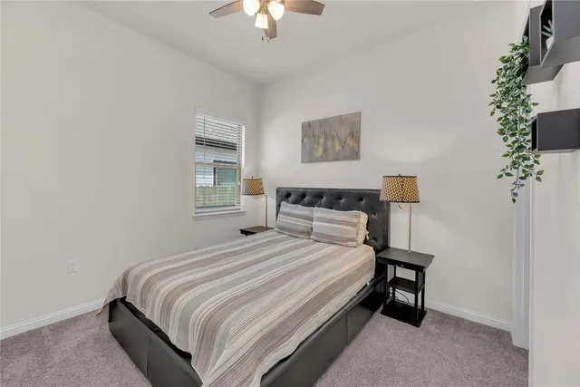 a bathroom with a granite countertop sink a toilet and a mirror
