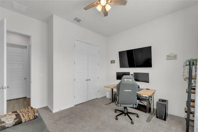 a view of a livingroom with workspace and a window