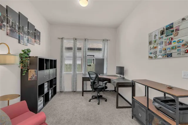 a view of a livingroom with workspace and a couch