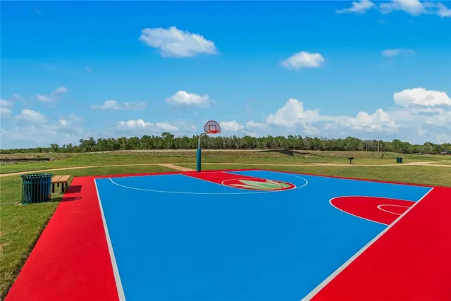 a view of swimming pool with lawn chairs and a yard