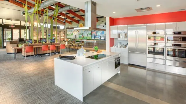a kitchen with stainless steel appliances a stove a refrigerator and cabinets