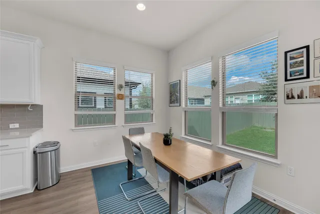 a kitchen with refrigerator and cabinets
