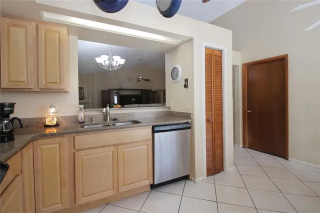 a kitchen with stainless steel appliances granite countertop a sink and cabinets