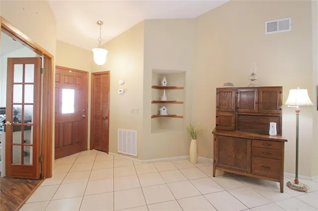 a kitchen with a refrigerator and cabinets