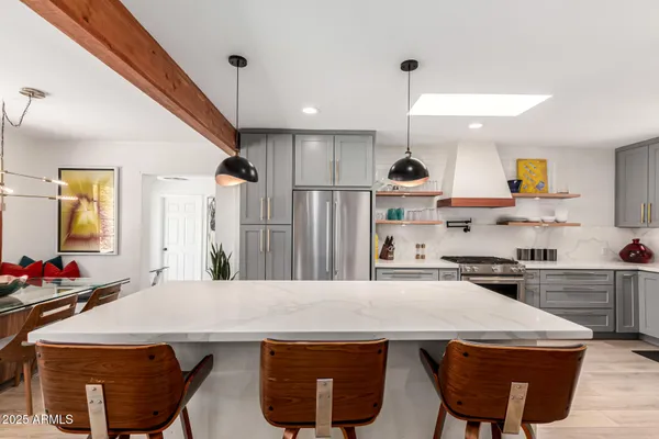 a kitchen with stainless steel appliances a stove a sink and cabinets