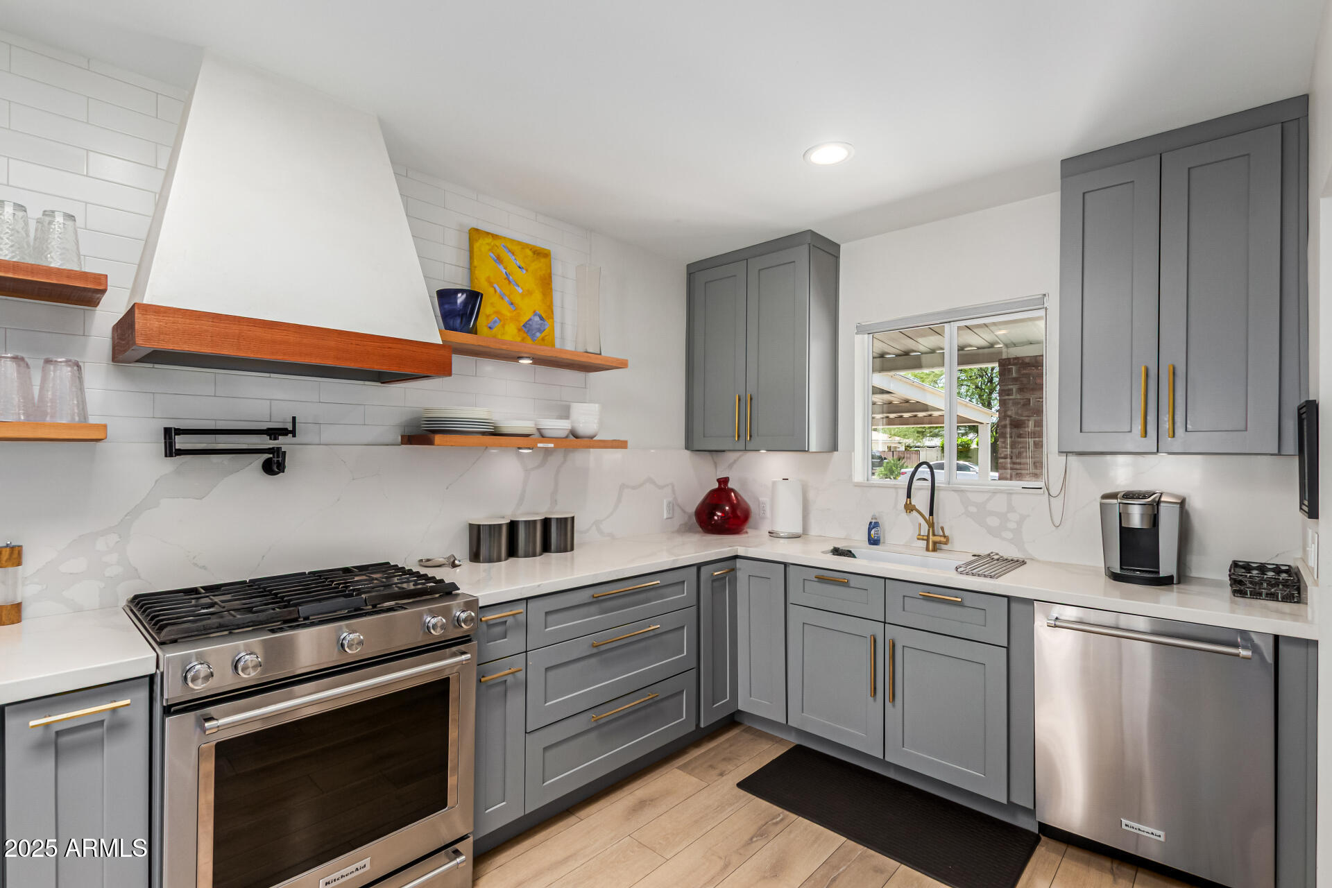 3809 North 35th Street Phoenix, AZ 85018 - Photo 19 of 43 a kitchen with stainless steel appliances a stove a sink and cabinets