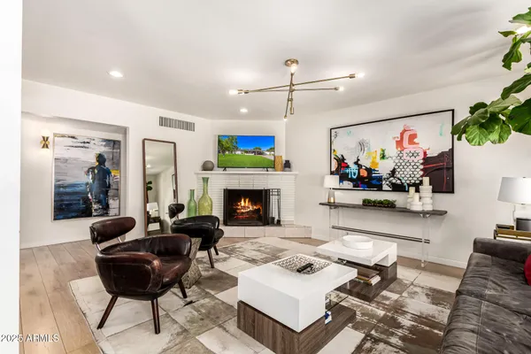 a living room with furniture fireplace and a table