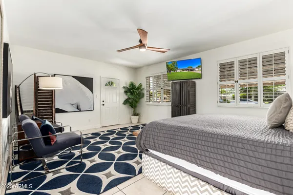 a bedroom with a bed and a flat screen tv