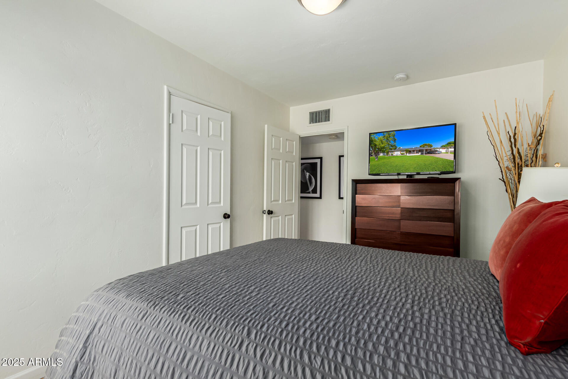3809 North 35th Street Phoenix, AZ 85018 - Photo 24 of 43 a bedroom with a bed and a flat screen tv