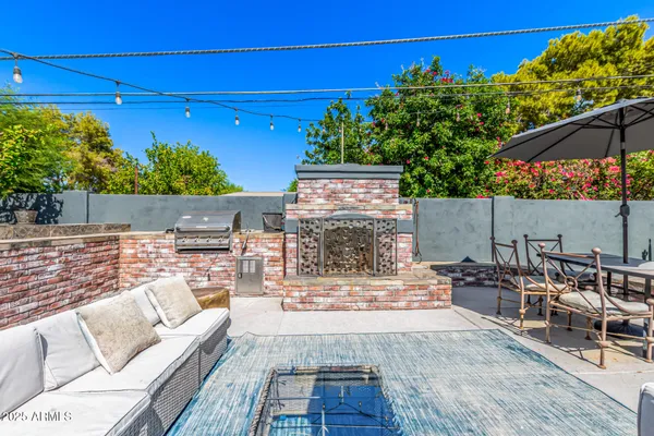 a view of house with backyard and patio