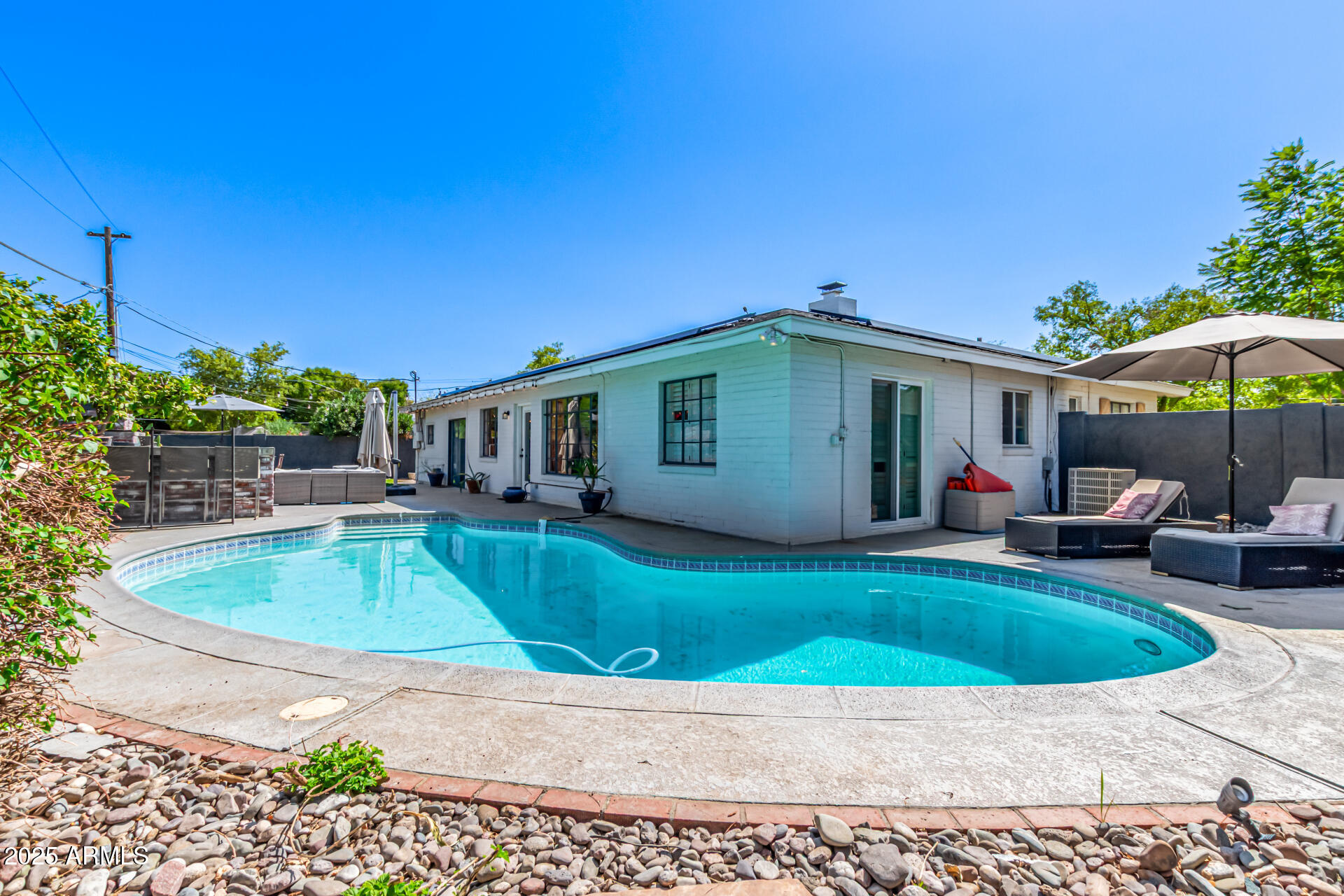 3809 North 35th Street Phoenix, AZ 85018 - Photo 4 of 43 a view of a house with backyard sitting area and swimming pool