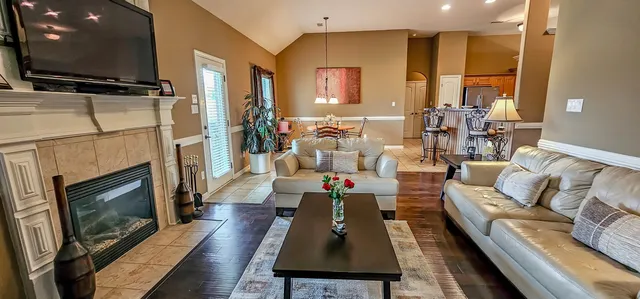 a living room with furniture flat screen tv and a fireplace