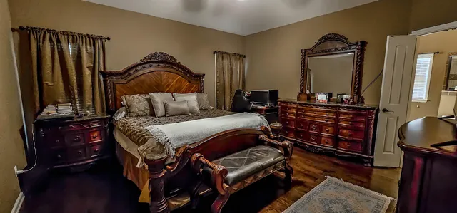 a bedroom with a bed and wooden floor