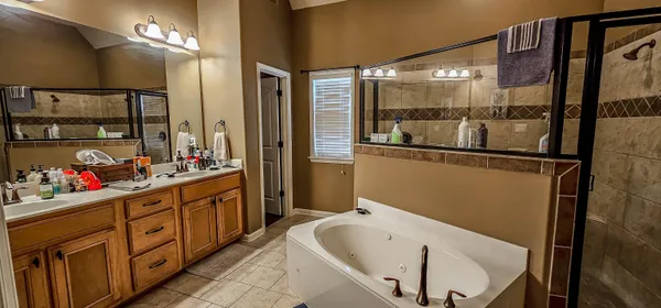 a bathroom with a tub sink and mirror