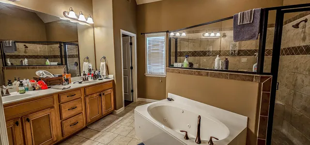 a bathroom with a tub sink and mirror