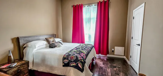 a bedroom with a bed and a window