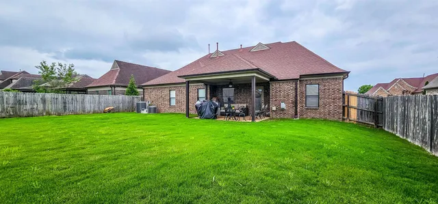 a front view of house with yard and outdoor seating
