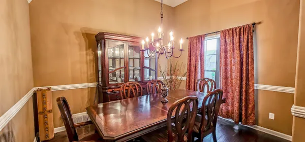 a view of a dining room with furniture and chandelier