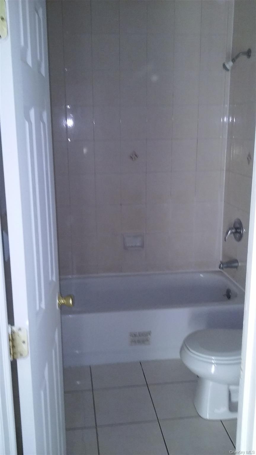 97-56 105th Street, Unit 2 Queens, NY 11416 - Photo 20 of 29 a bathroom with a toilet and a shower