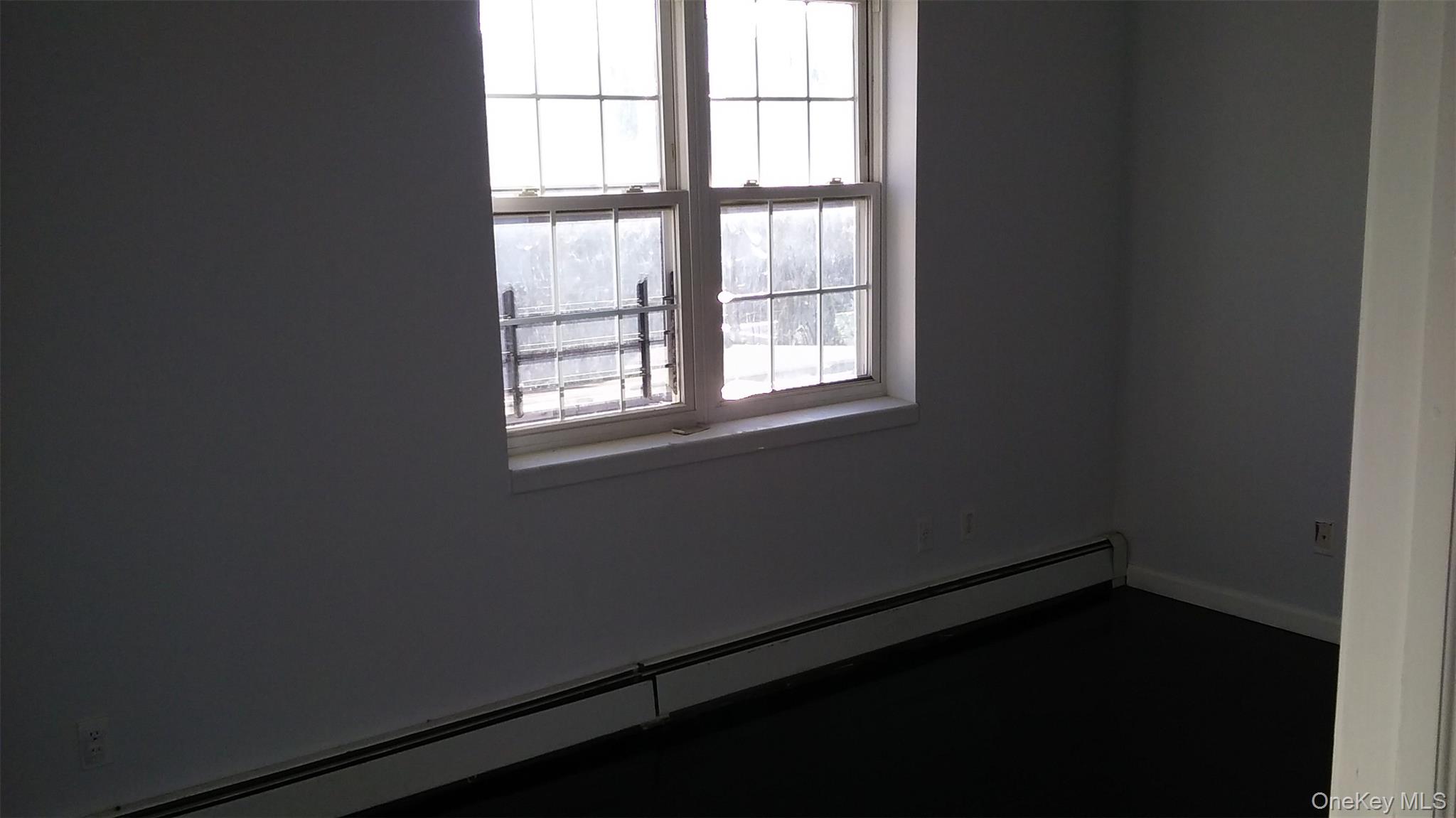 97-56 105th Street, Unit 2 Queens, NY 11416 - Photo 2 of 29 an empty room with a window