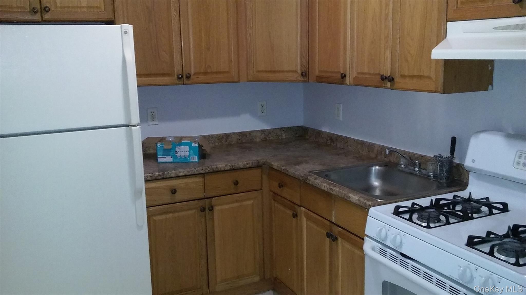 97-56 105th Street, Unit 2 Queens, NY 11416 - Photo 21 of 29 a kitchen with a refrigerator and a stove