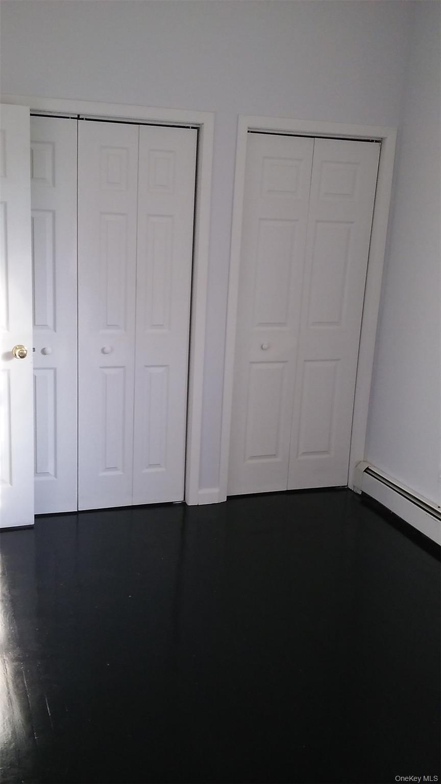 97-56 105th Street, Unit 2 Queens, NY 11416 - Photo 3 of 29 a view of an empty room with wooden floor