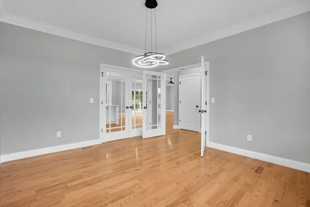 a spacious bedroom with a large bed and a flat screen tv