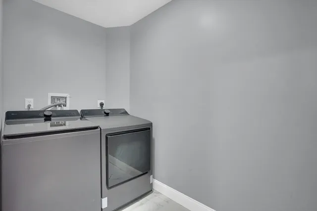 a bathroom with a double vanity sink toilet and a mirror