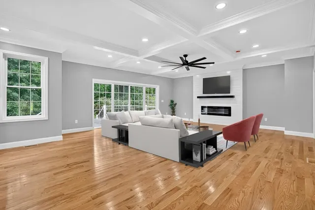 a large white kitchen with stainless steel appliances kitchen island granite countertop a stove and a sink