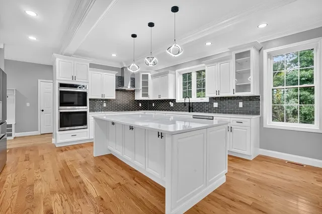 a view of empty room with wooden floor and window