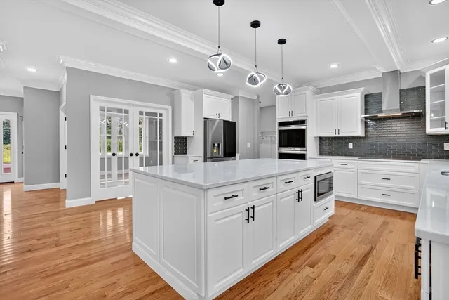 a view of an empty room with chandelier and a window