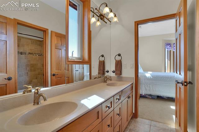 10980 Huntsman Road Colorado Springs, CO 80908 - Photo 23 of 35 Jack and Jill bath between bedrooms 2 and 3 upstairs with double vanity