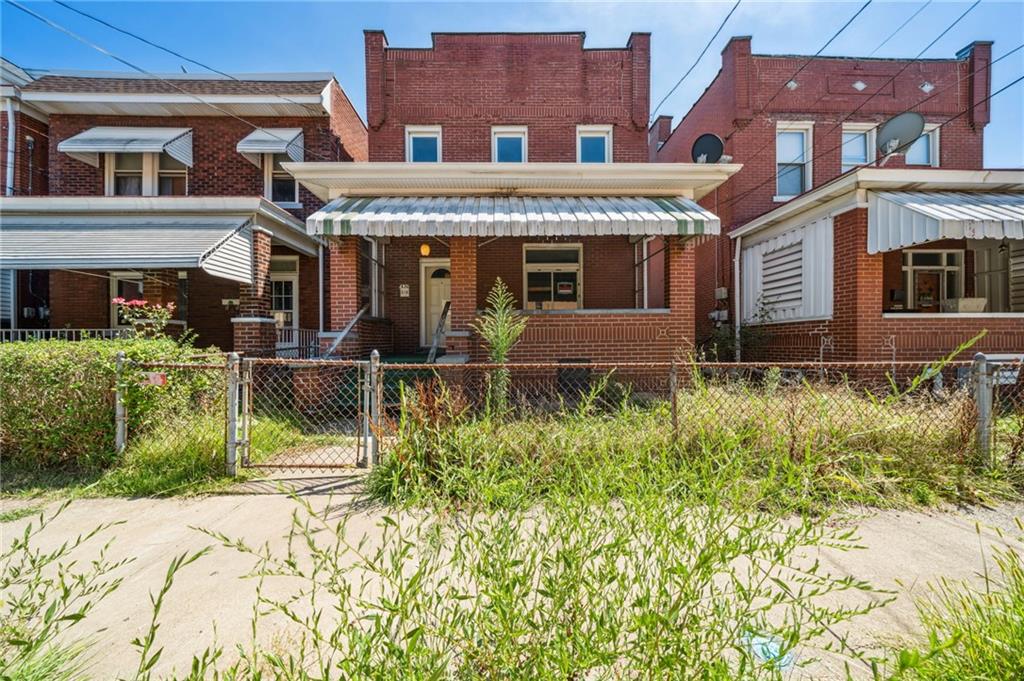 338 Catherine Street McKees Rocks, PA 15136 - Photo 1 of 25 front view of a brick house with a small yard