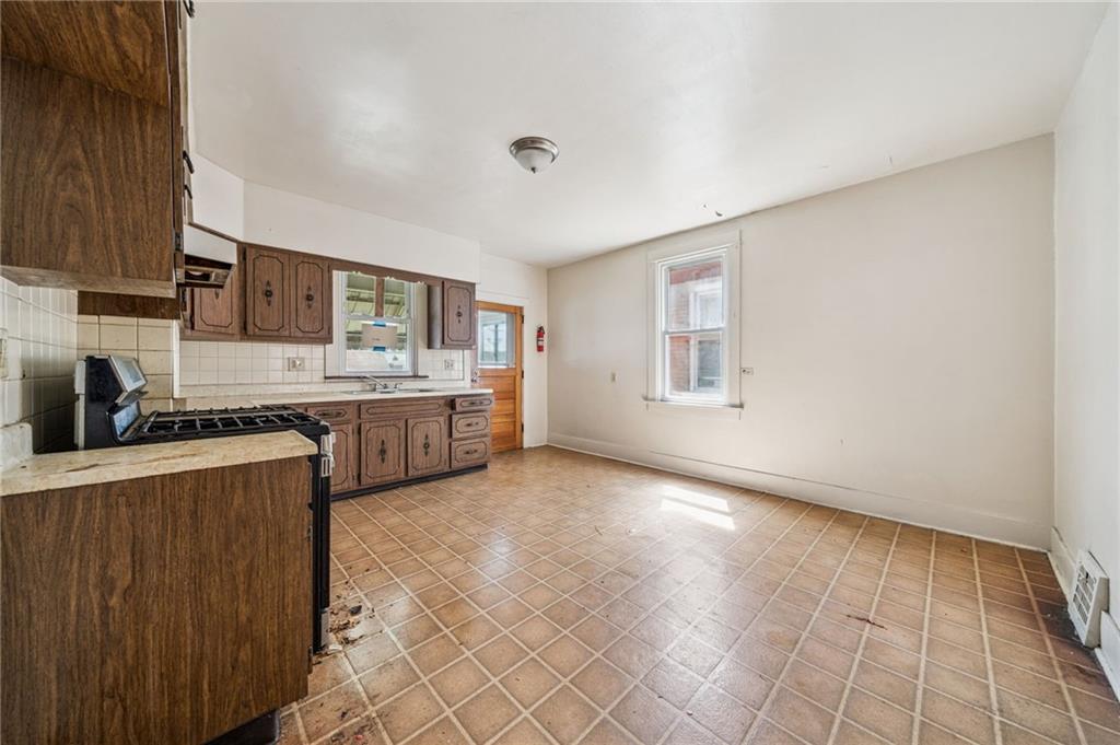 338 Catherine Street McKees Rocks, PA 15136 - Photo 15 of 25 a view of a kitchen with a sink cabinets and a window