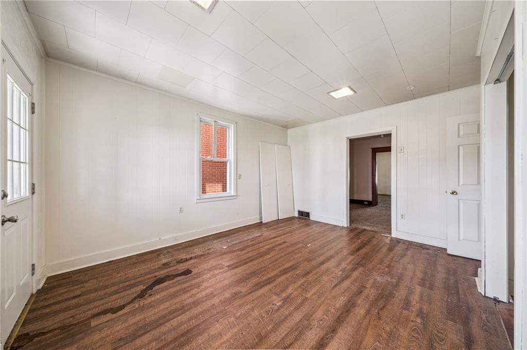 338 Catherine Street McKees Rocks, PA 15136 - Photo 10 of 25 a view of an empty room with wooden floor and a window