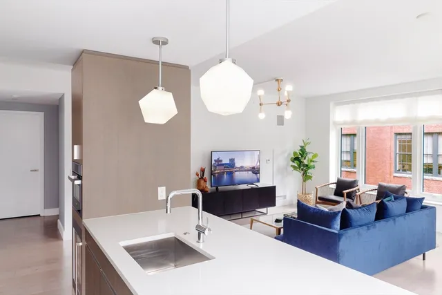 a living room with furniture a chandelier and a large mirror