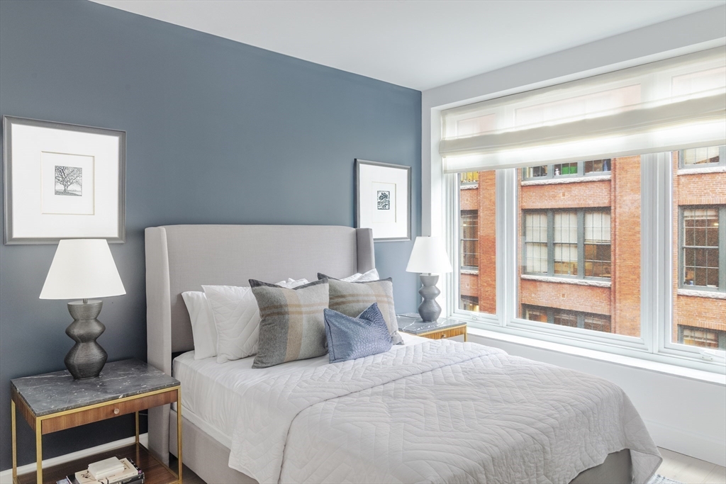 100 Lovejoy Wharf, Unit 6B Boston, MA 02114 - Photo 8 of 25 a bedroom with a bed and a window
