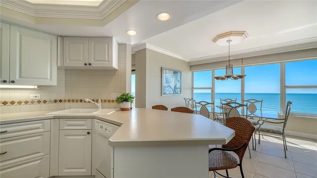 a kitchen with cabinets and chairs