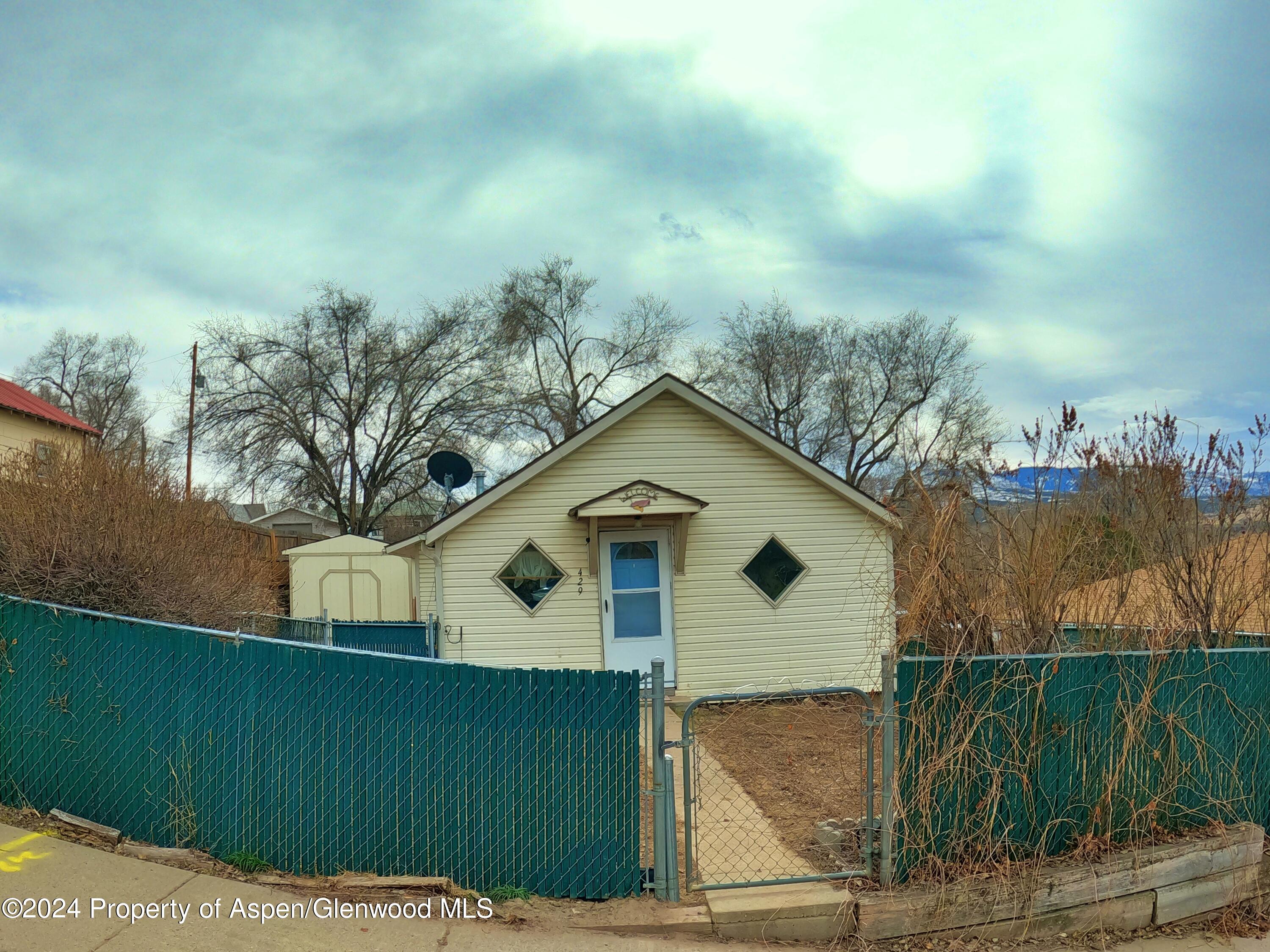429 East 7th Street Rifle, CO 81650 - Photo 2 of 17 a front view of a house with a yard