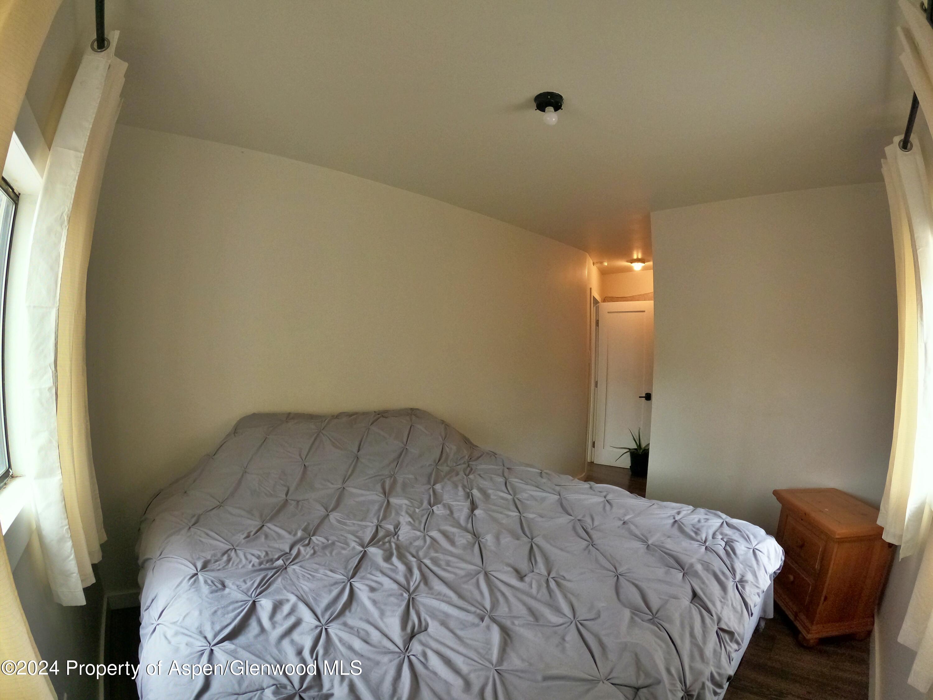 429 East 7th Street Rifle, CO 81650 - Photo 10 of 17 a bedroom with a bed and a window