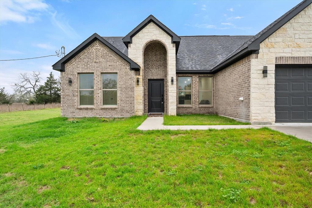 6771 Northwest County Road 1146 Barry, TX 75102 - Photo 28 of 34 a front view of a house with a yard