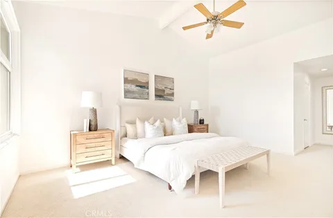 a bedroom with a bed and a lamp with the wall painting