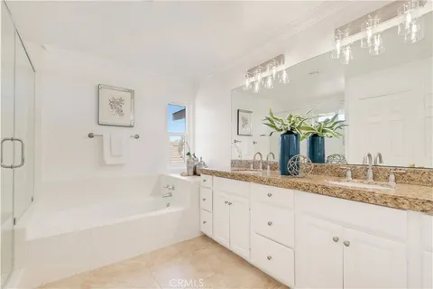 a bathroom with a granite countertop sink mirror and bathtub